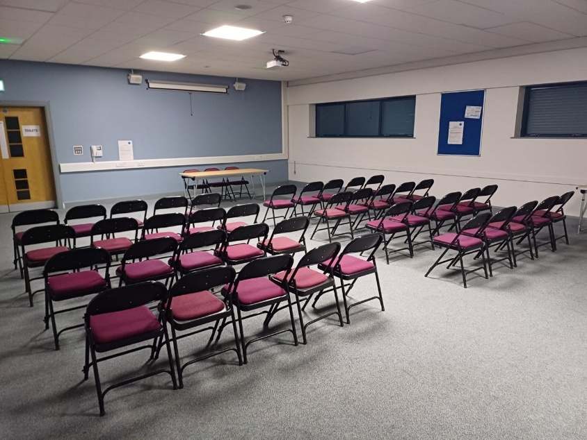 Meeting room arranged with rows of seating