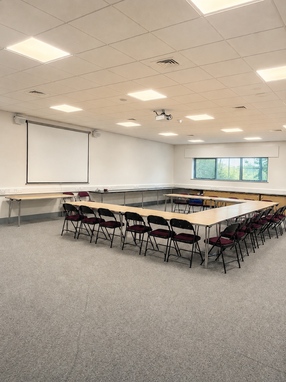 Training room arranged with tables and seating